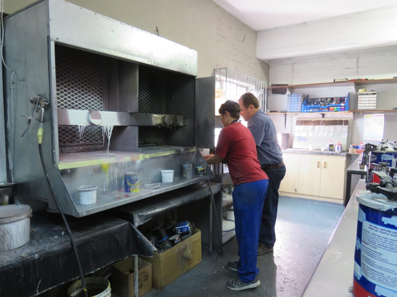 Staff mixing paint at the station